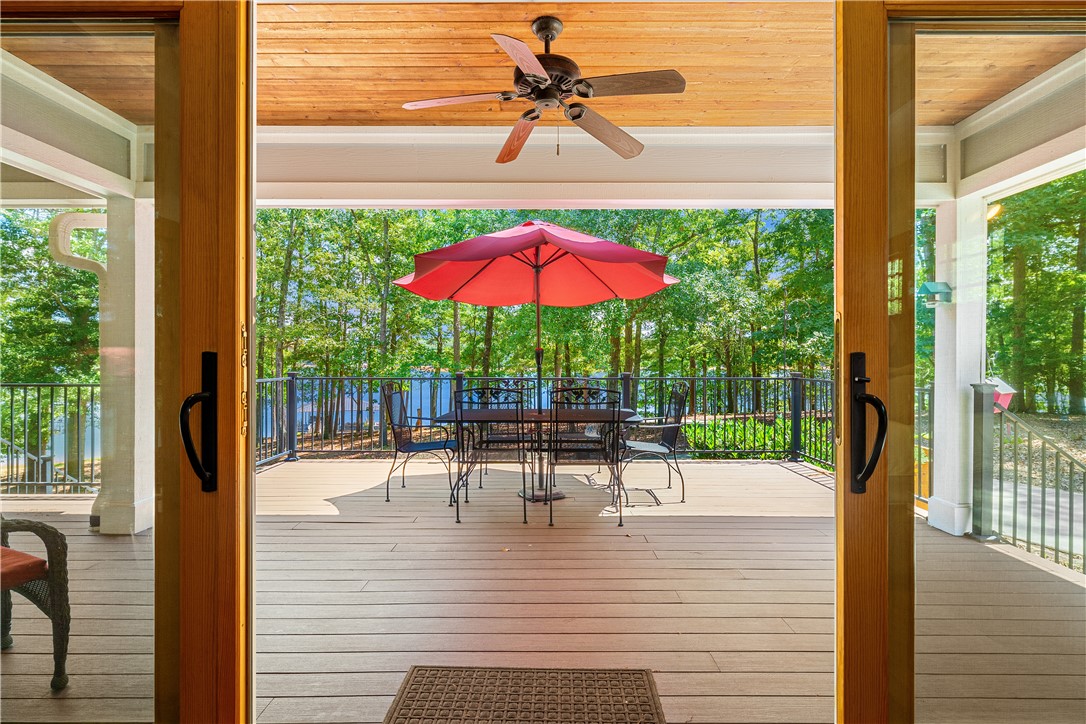 285 Bertha Allen Road Westminster, SC 29693 - Photo 17 of 50 Sliding doors unveil an inviting deck, perfect for waterfront entertaining amidst lush greenery.