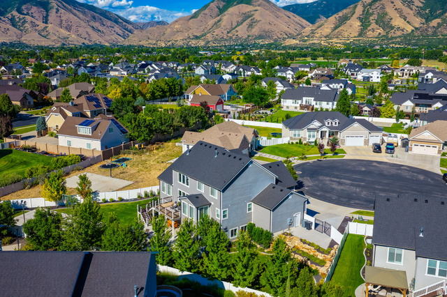 1132 South 1300th Street West Mapleton, UT 84664 - Photo 51 of 52 This aerial perspective showcases a residential neighborhood nestled against a mountainous backdrop