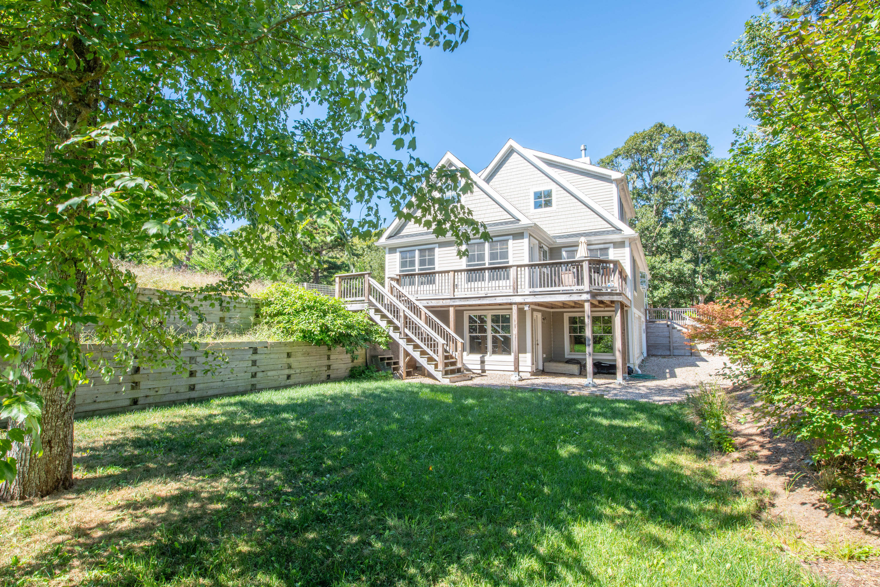 a front view of a house with a yard and potted plants