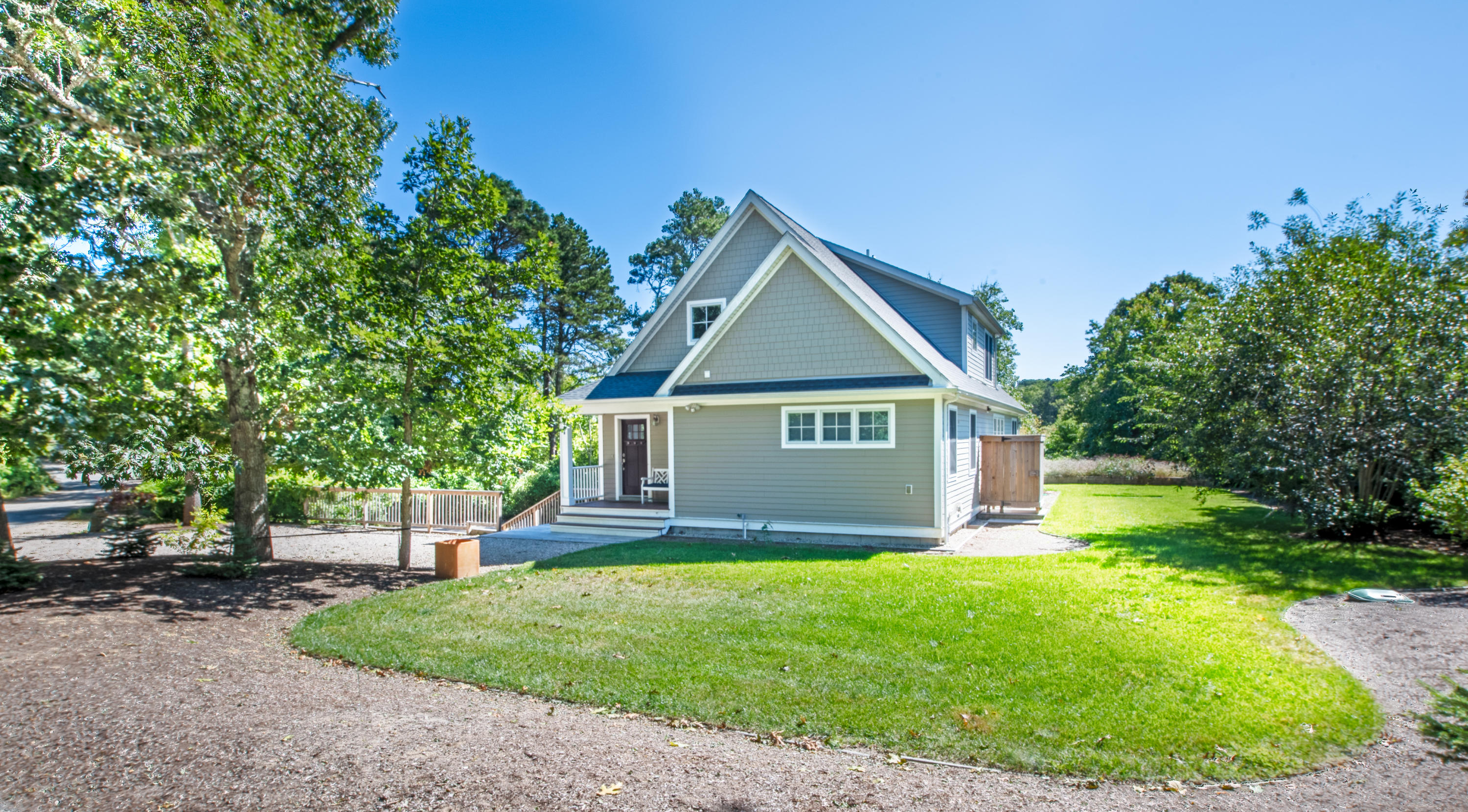 100 Peace Valley Road Wellfleet, MA 02667 - Photo 3 of 33 a view of a house with a small yard and a large tree