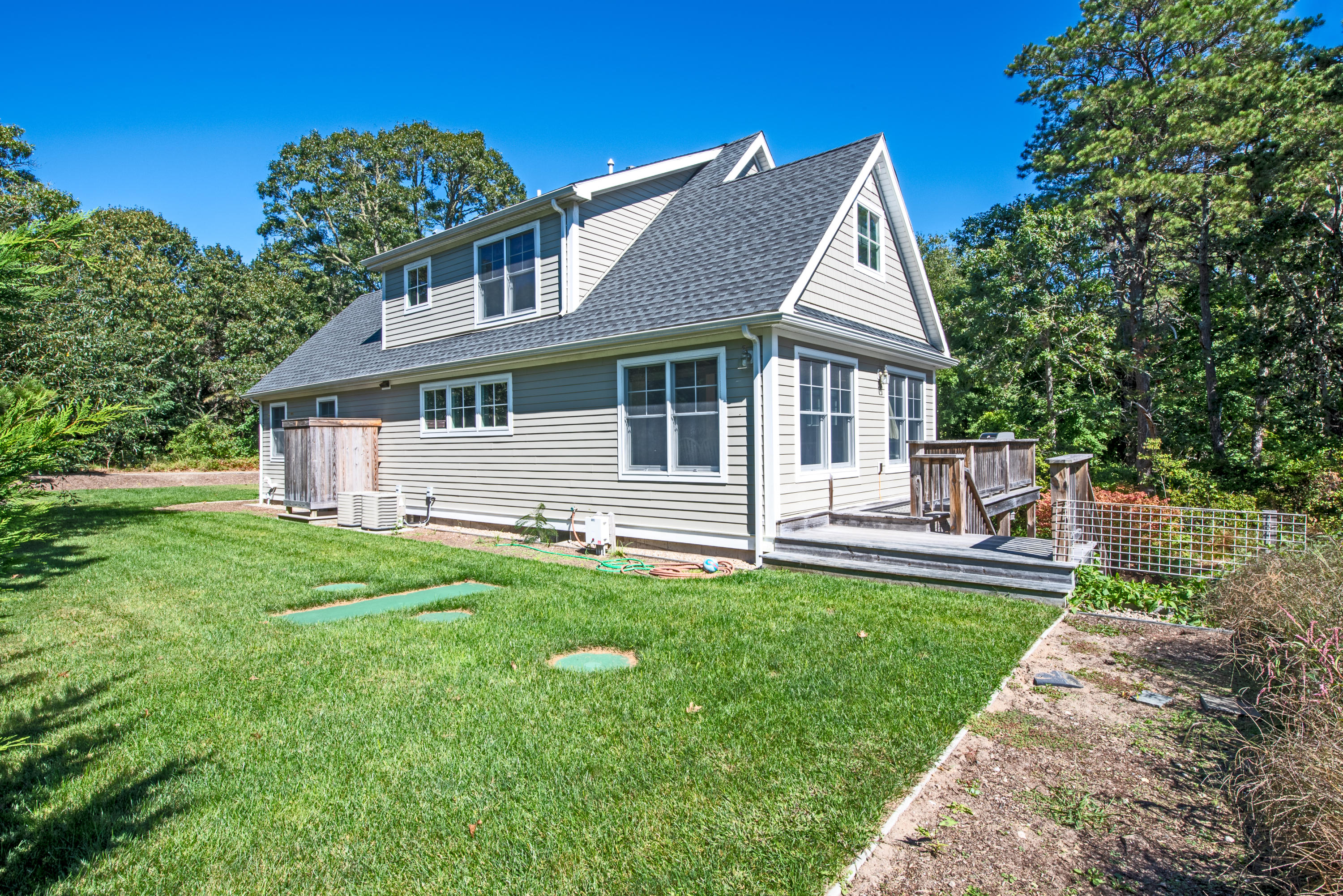 100 Peace Valley Road Wellfleet, MA 02667 - Photo 5 of 33 a front view of a house with a yard and trees