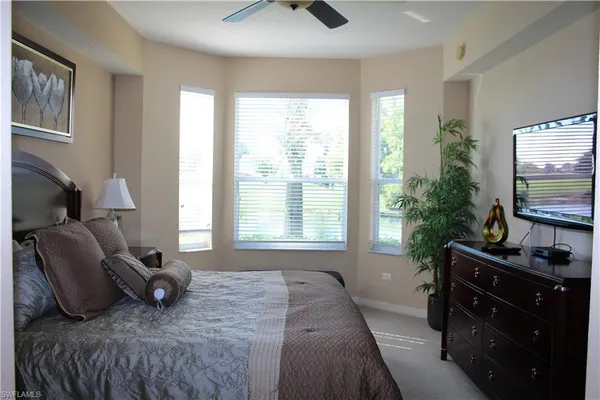 a bedroom with a bed and flat screen tv