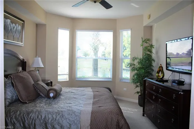 a bedroom with a bed and flat screen tv