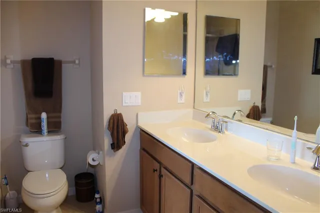 a bathroom with a toilet sink and mirror