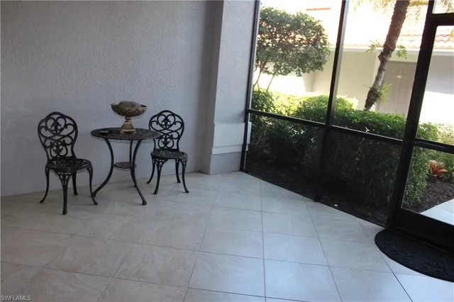 a view of a chairs and table in the balcony