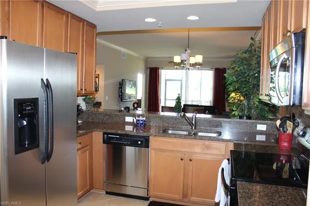 a kitchen with stainless steel appliances a sink stove and cabinets