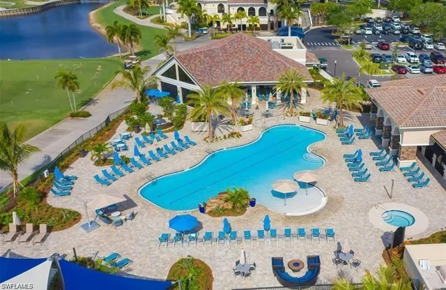 a view of a swimming pool with outdoor seating