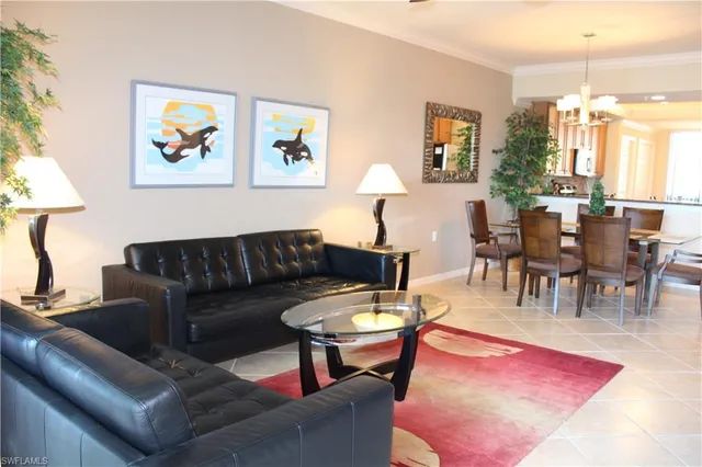 a living room with furniture a rug and a lamp