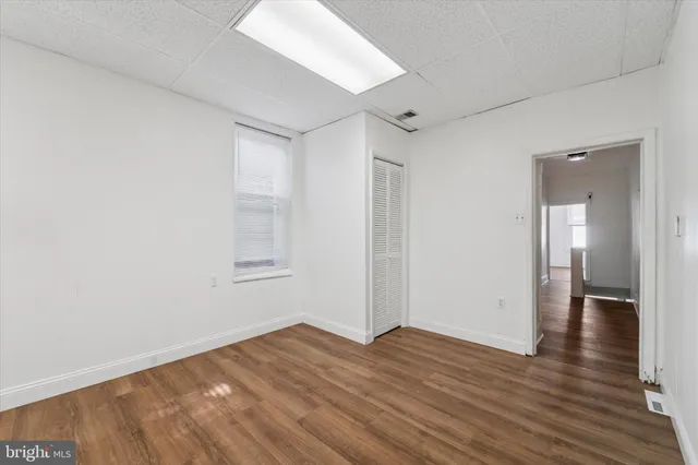 a view of a room with wooden floor and bathroom