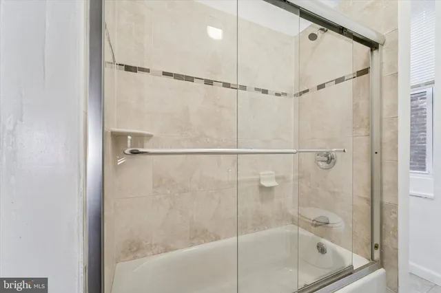 a bathroom with a bath tub and shower