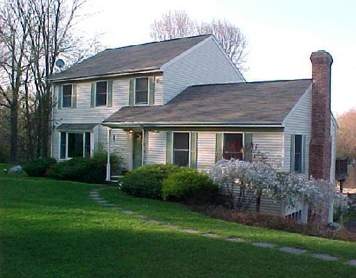 107 Ivy Hill Road Ridgefield, CT 06877 - Photo 1 of 1 a front view of house with yard and green space