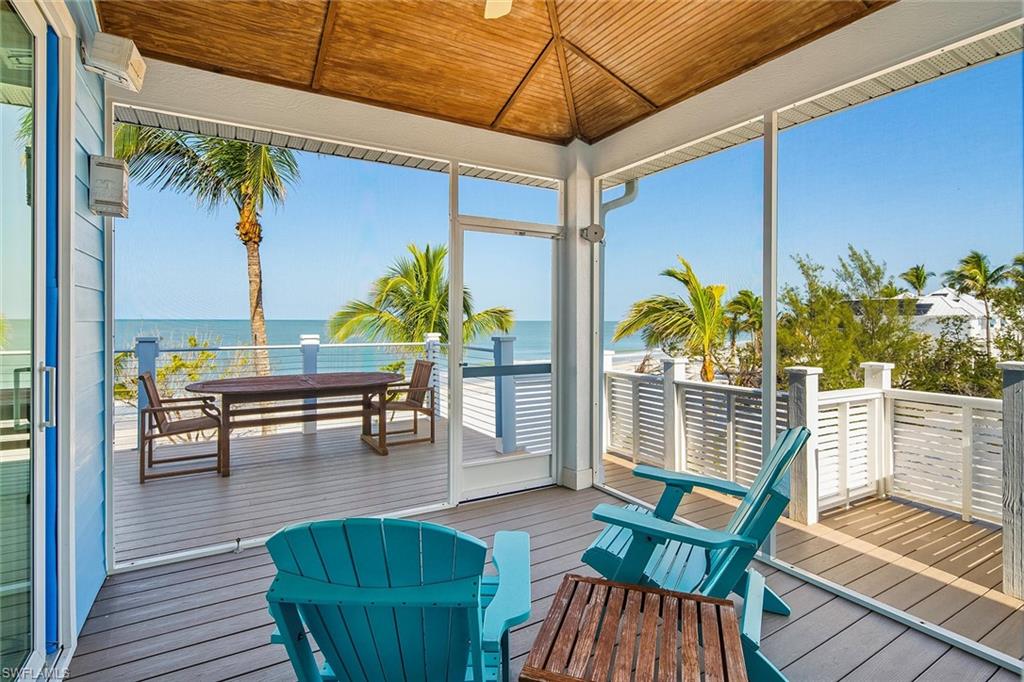 11687 Keewaydin Naples, FL 34113 - Photo 12 of 49 a view of a patio with table and chairs potted plants with wooden floor