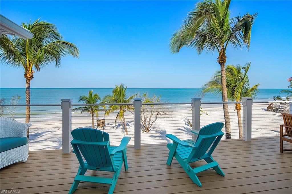 11687 Keewaydin Naples, FL 34113 - Photo 13 of 49 a view of a chairs and table on the wooden deck
