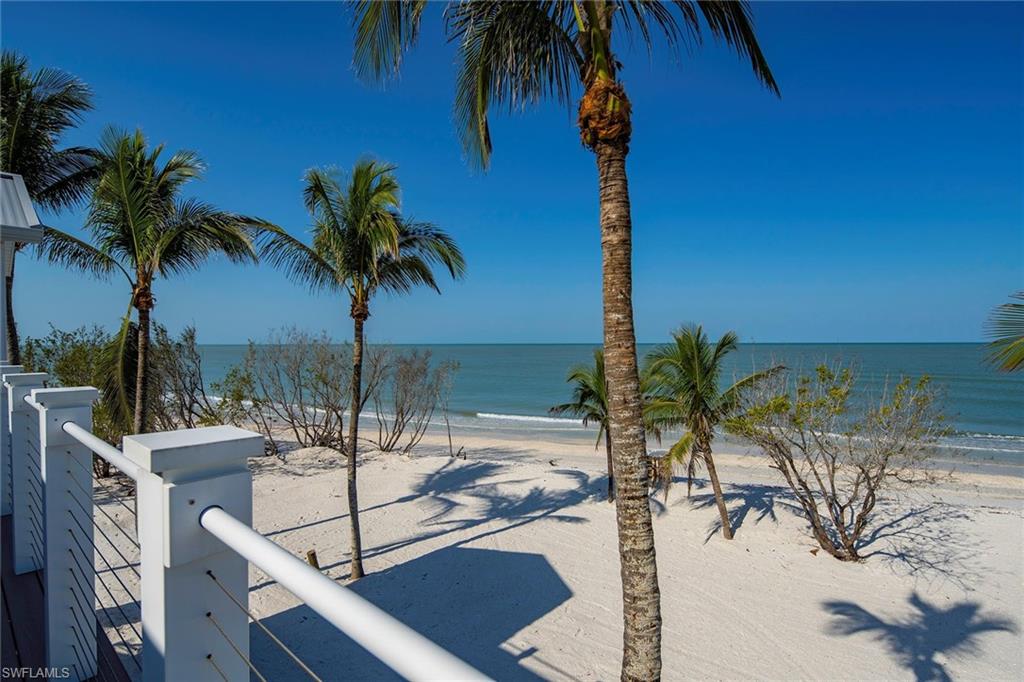 11687 Keewaydin Naples, FL 34113 - Photo 14 of 49 a view of a palm tree with dinning table in a patio