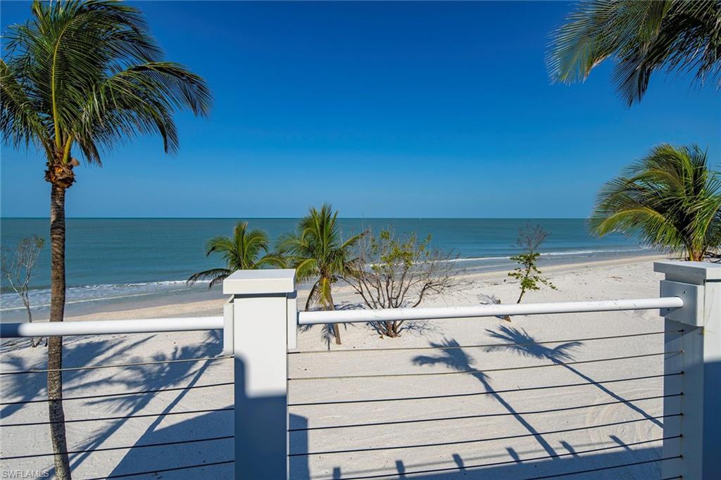 11687 Keewaydin Naples, FL 34113 - Photo 15 of 49 a view of a swimming pool with a table and chairs