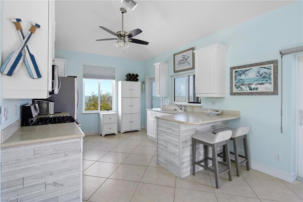 11687 Keewaydin Naples, FL 34113 - Photo 17 of 49 a kitchen with a sink appliances and cabinets