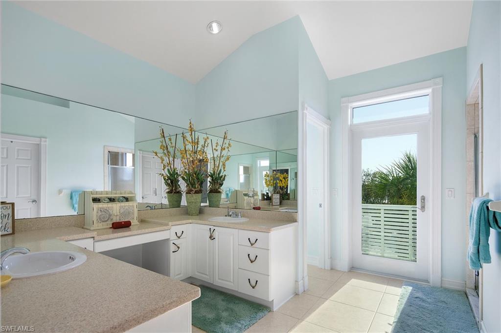 11687 Keewaydin Naples, FL 34113 - Photo 23 of 49 a spacious en suite bathroom with a double vanity sink a large mirror and a shower