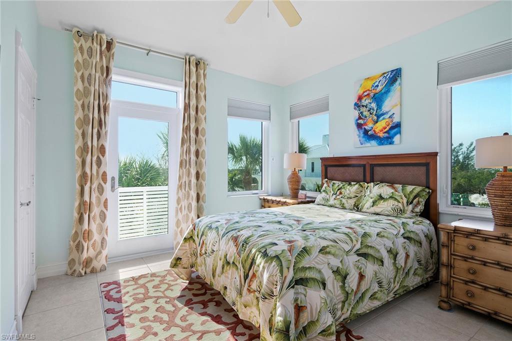 11687 Keewaydin Naples, FL 34113 - Photo 24 of 49 a bedroom with a bed and a painting on the wall
