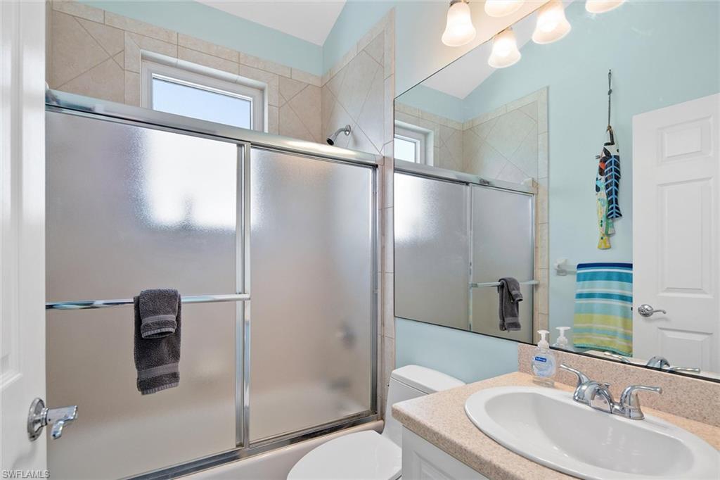 11687 Keewaydin Naples, FL 34113 - Photo 25 of 49 a bathroom with a sink toilet and shower