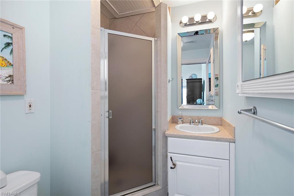 11687 Keewaydin Naples, FL 34113 - Photo 28 of 49 a bathroom with a sink toilet and vanity