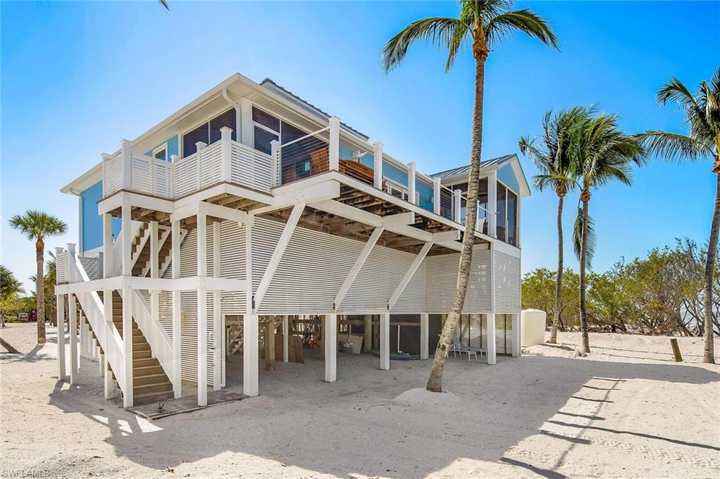 11687 Keewaydin Naples, FL 34113 - Photo 34 of 49 a front view of a house with a yard