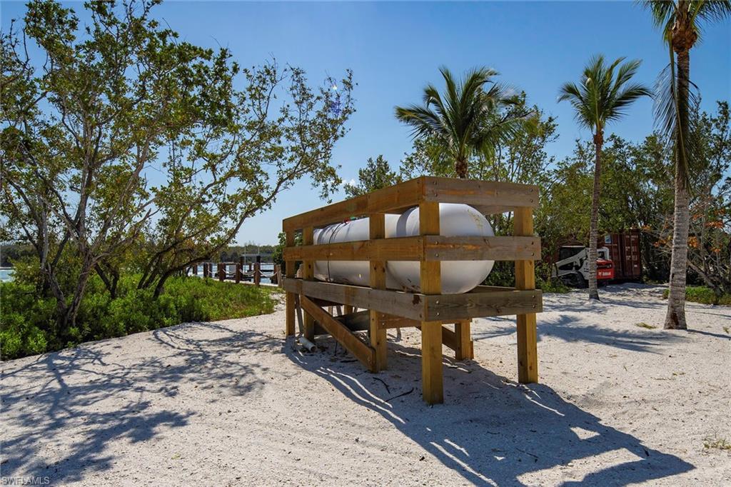 11687 Keewaydin Naples, FL 34113 - Photo 36 of 49 a view of a wooden bench sitting in backyard