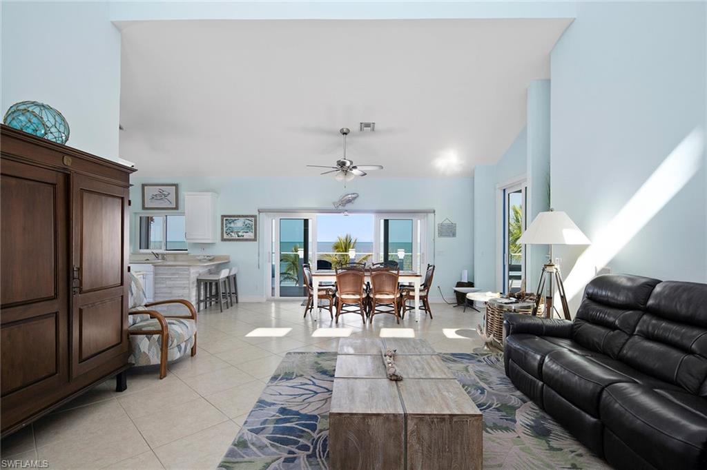 11687 Keewaydin Naples, FL 34113 - Photo 6 of 49 a living room with furniture and a chandelier