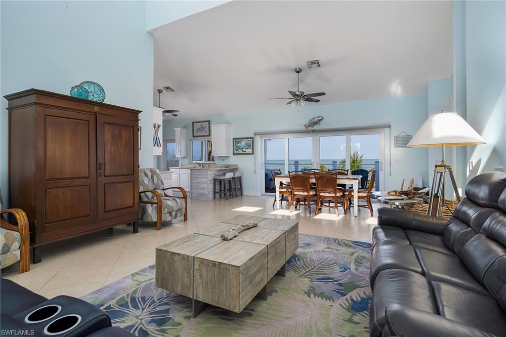 11687 Keewaydin Naples, FL 34113 - Photo 8 of 49 a living room with furniture and a chandelier
