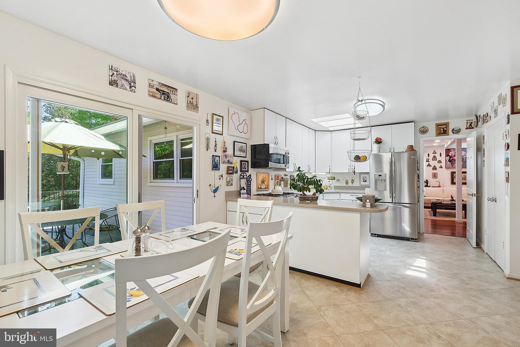 12012 Coldstream Drive Potomac, MD 20854 - Photo 13 of 42 a kitchen with stainless steel appliances kitchen island granite countertop a table and chairs in it
