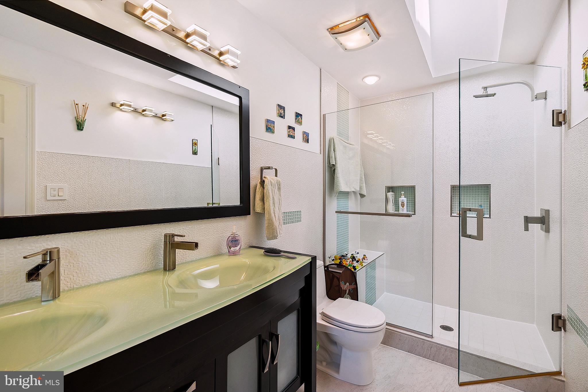 12012 Coldstream Drive Potomac, MD 20854 - Photo 15 of 42 a bathroom with a double vanity sink mirror and toilet