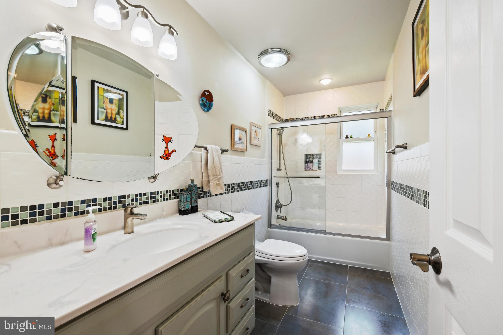 12012 Coldstream Drive Potomac, MD 20854 - Photo 20 of 42 a bathroom with a granite countertop sink toilet and shower