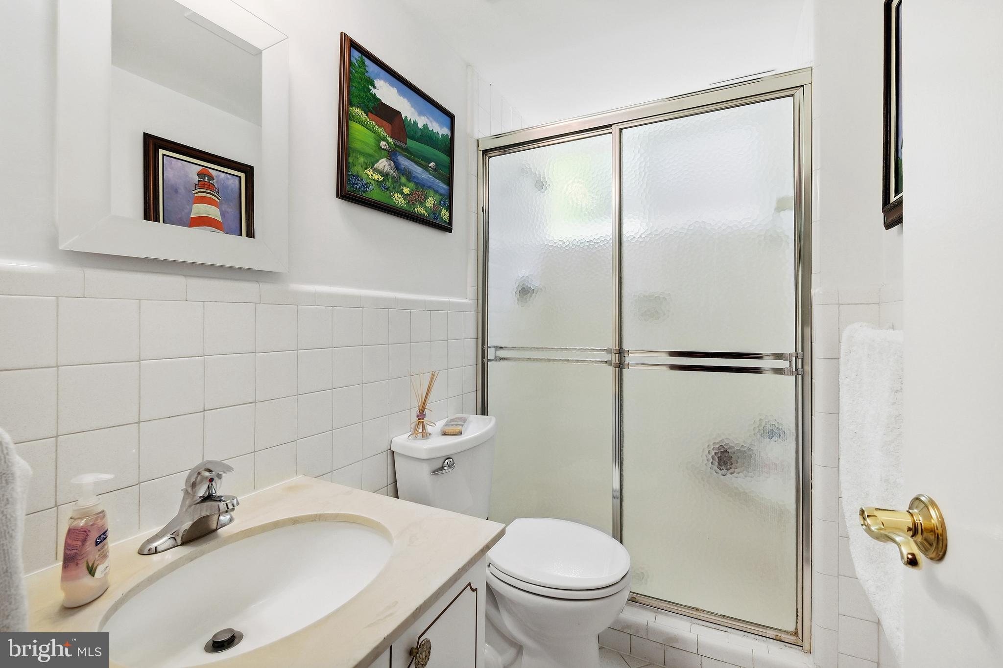 12012 Coldstream Drive Potomac, MD 20854 - Photo 24 of 42 a bathroom with a sink toilet and shower