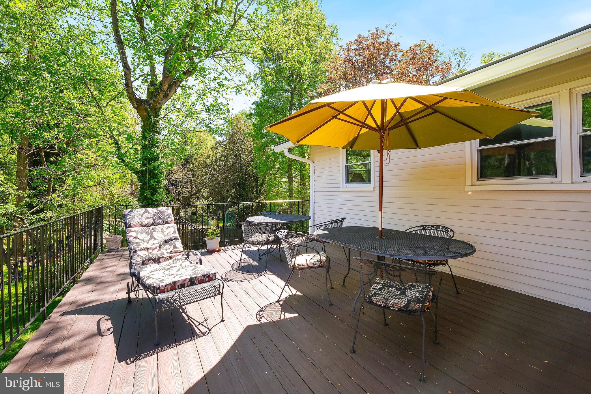 12012 Coldstream Drive Potomac, MD 20854 - Photo 34 of 42 an outdoor sitting area with furniture and umbrella