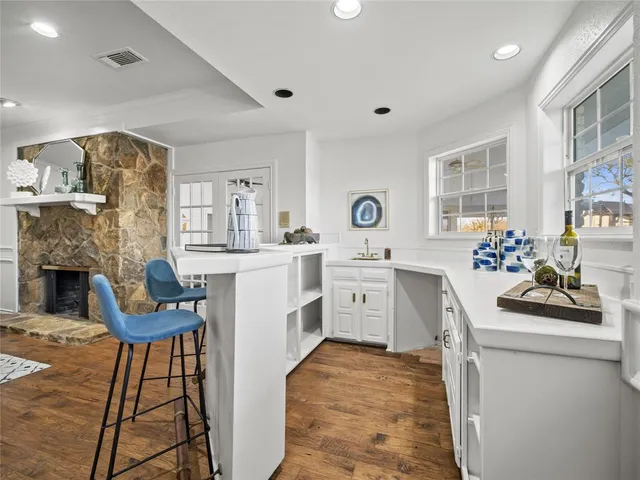 a living room with furniture a fireplace and kitchen view