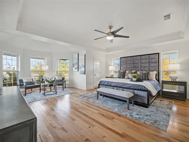 a bedroom with furniture and wooden floor