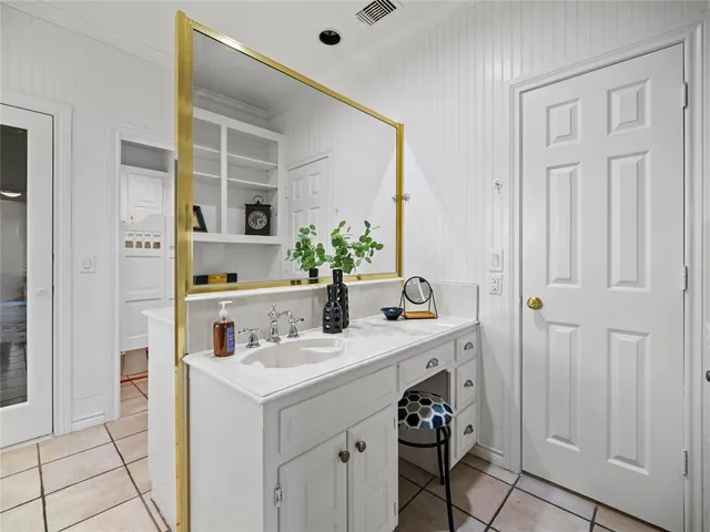 a bathroom with a sink vanity and a mirror