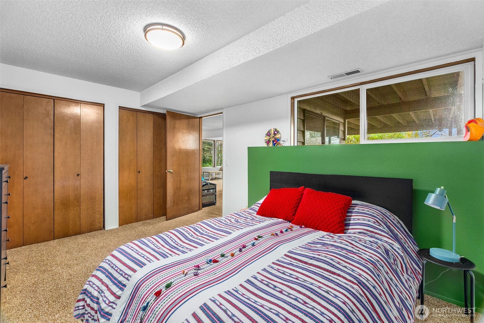 6028 Northill Loop Southwest Olympia, WA 98512 - Photo 23 of 38 a bedroom with a large bed and a large window