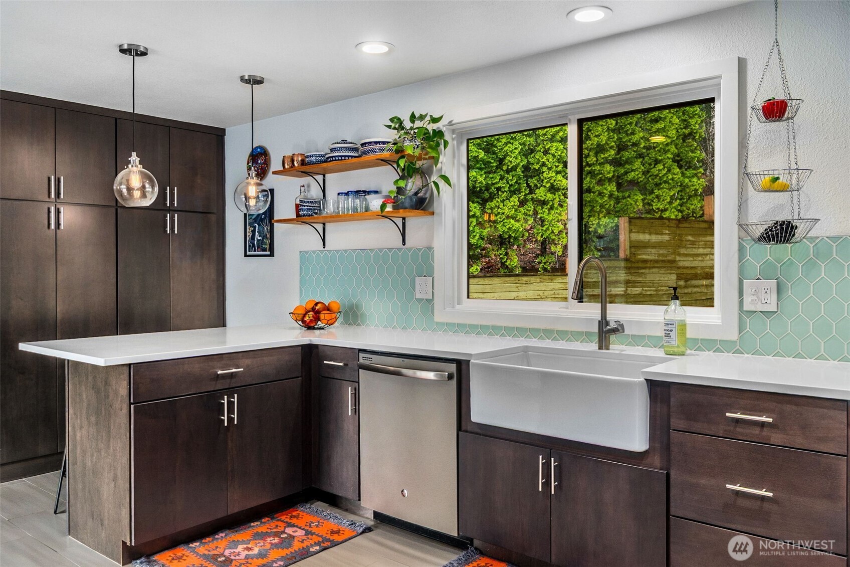 6028 Northill Loop Southwest Olympia, WA 98512 - Photo 3 of 38 a kitchen with kitchen island a sink appliances and a large window