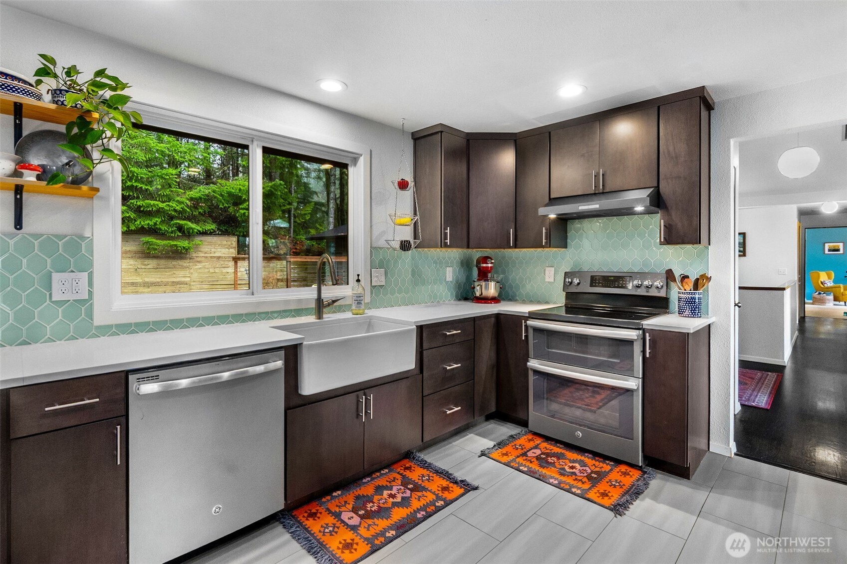 6028 Northill Loop Southwest Olympia, WA 98512 - Photo 4 of 38 a kitchen with stainless steel appliances granite countertop a sink stove and refrigerator