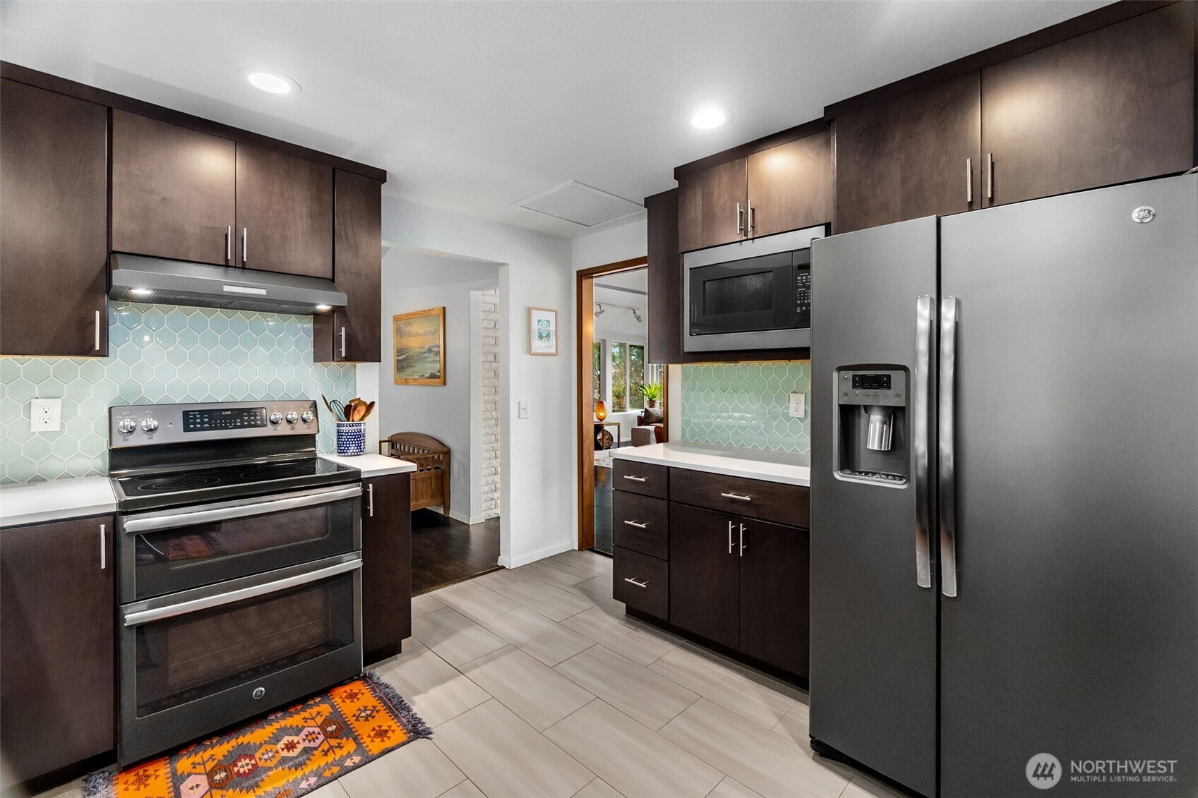 6028 Northill Loop Southwest Olympia, WA 98512 - Photo 6 of 38 a kitchen with stainless steel appliances wooden cabinets and stove top oven