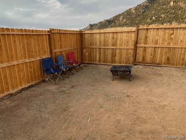 930 Garfield Road Hartsel, CO 80449 - Photo 12 of 12 a backyard of a house with table and chairs