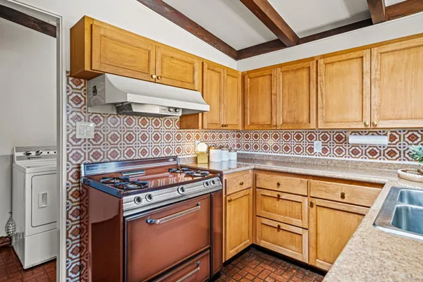 a kitchen with granite countertop cabinets stainless steel appliances and a sink