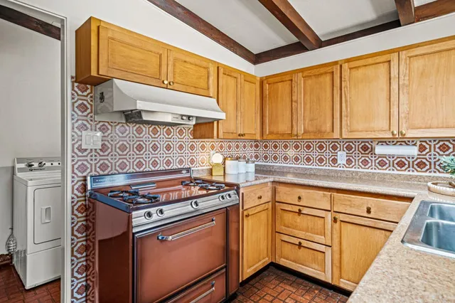 a kitchen with granite countertop cabinets stainless steel appliances and a sink