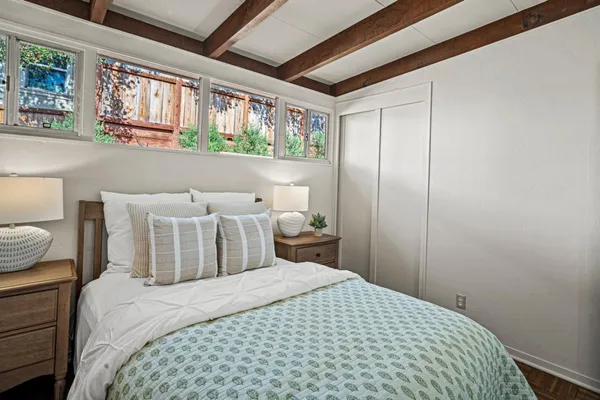a bedroom with a bed and a window