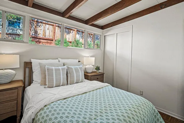 a bedroom with a bed and a window