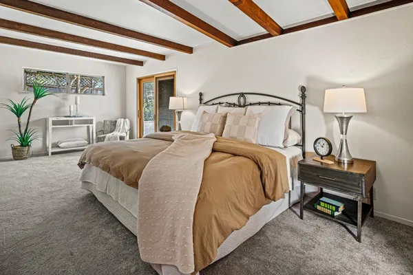 a bedroom with bed and a table lamp