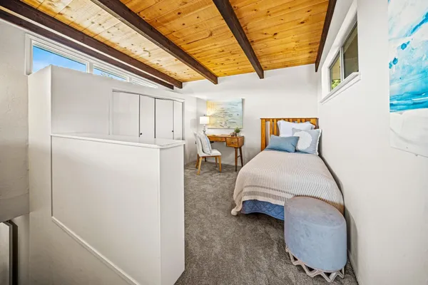 a bedroom with bed and a chandelier