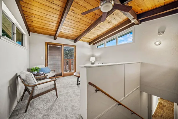 a outdoor space with lots of furniture and a ceiling fan