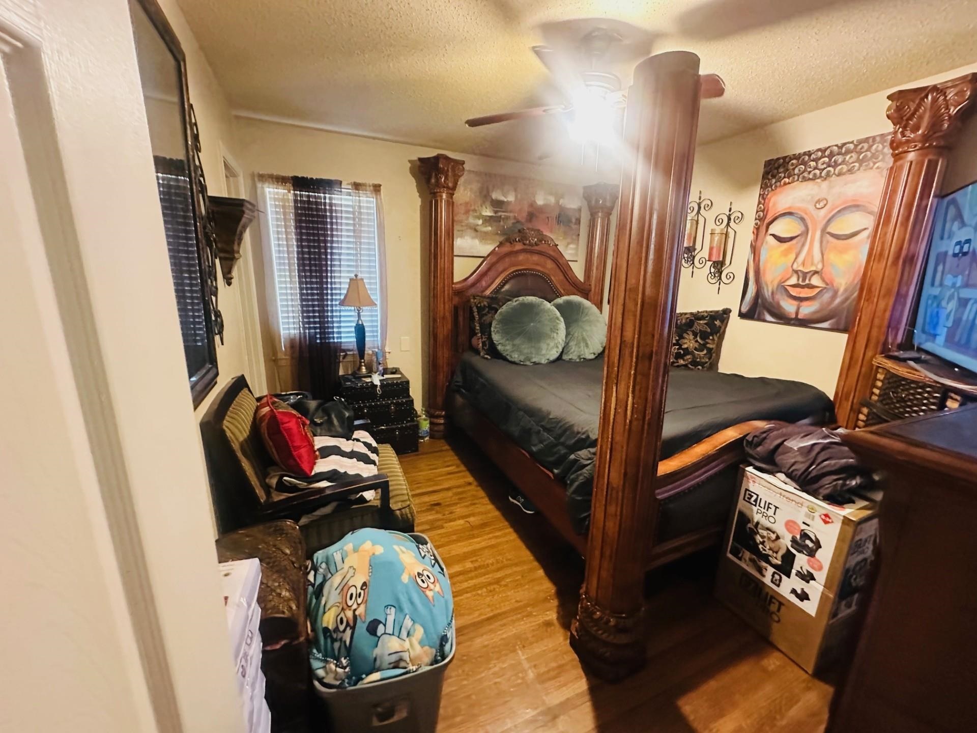 4775 Stacey Road Memphis, TN 38109 - Photo 11 of 13 Bedroom with a textured ceiling, light wood-style flooring, and a ceiling fan