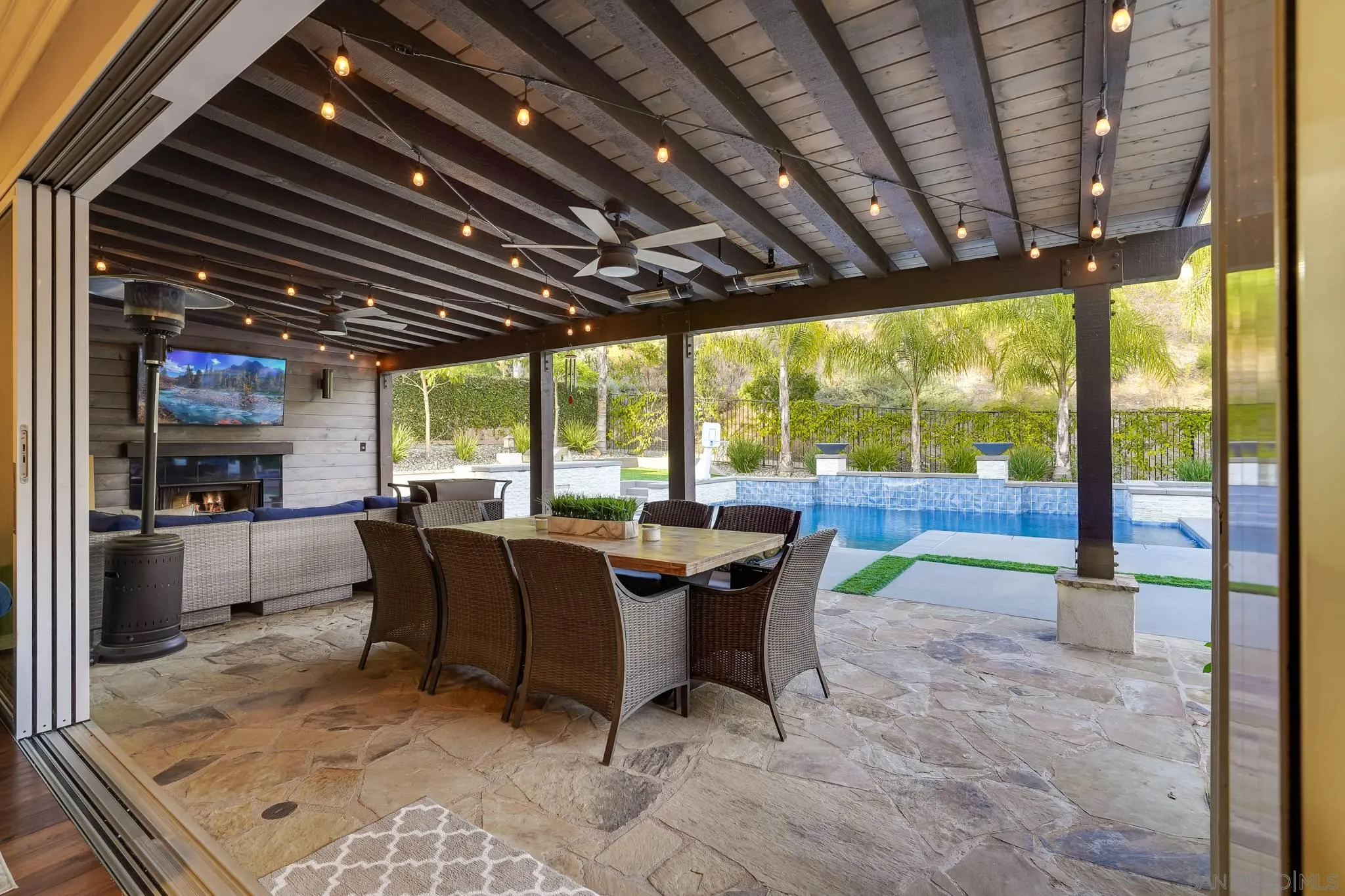 16375 Cayenne Ridge Road San Diego, CA 92127 - Photo 1 of 35 a view of a patio with a table chairs and a small yard